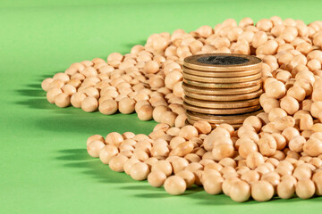 Soybeans and brazilian Real coins on a green background in Brazil