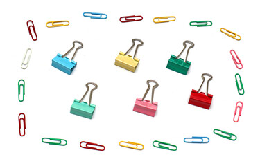 Paper clips and binders on paper