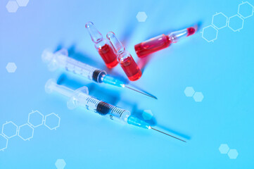 Disposable syringe, vaccine with abstract graphics on blue background. Medical concept