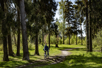 Fototapeta na wymiar Young man riding a bike in the forest