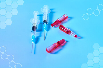 Disposable syringe, vaccine with abstract graphics on blue background. Medical concept