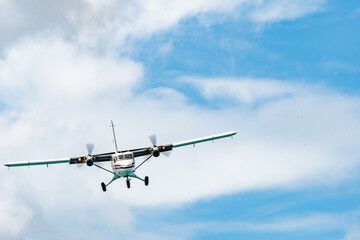 Fototapeta na wymiar Twin otter DHC-6-300 aircraft with wheels down prepares to land