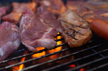 Close up images of barbecuing meat on a grill.