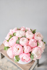 Pink peonies in pink round box. Beautiful peony for catalog or online store. Floral shop concept. Flowers delivery