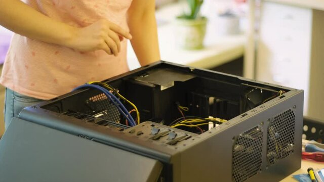 Young female fixing desktop computer