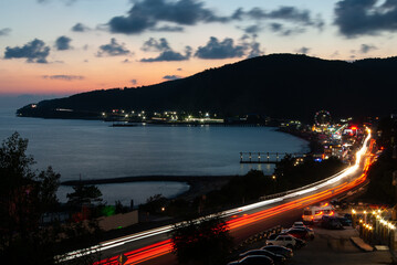 Light trails after dark on an oceanside highway Black Sea, Lermontovo