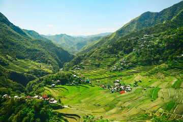 Traditional village in the middle of rice terraces. Panoramic view from a high point.