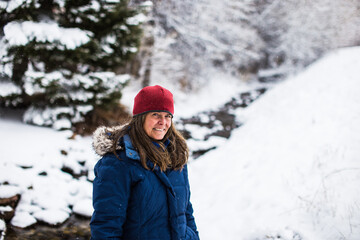 Fototapeta na wymiar A beautiful woman enjoying a day in a winter forest in Colorado, USA
