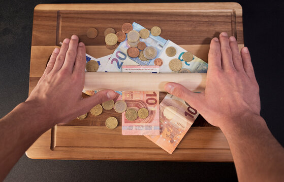 wooden board full of euro bills and euro coins crisisOutbreak effect of the world novel coronavirus (Covid-19) in the EU, the world economy, the financial crisis, investment, the stock market. Coronav