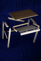 Parts of the desk levitate against a dark blue background.