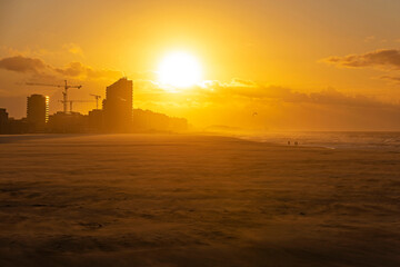 Fototapeta premium The beach of Oostende (Ostend in English) and its skyline at sunset with strong wind along the North Sea, West Flanders, Belgium.