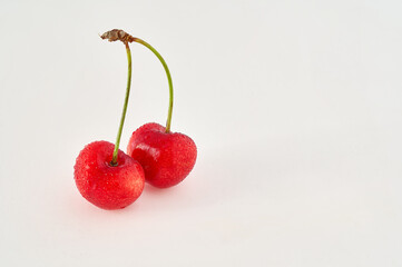 Bunch of two cherries, summer seasonal fruit, on white background
