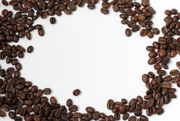 Roasted arabica beans on a white background. Frame from coffee beans with a free area.