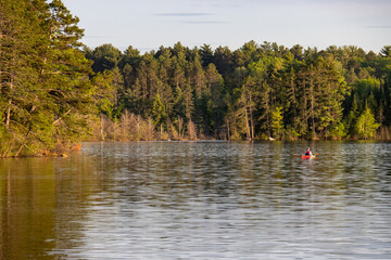 man in kayak fishing in the lake