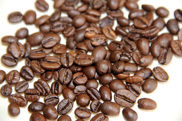 coffee beans are scattered on a white background