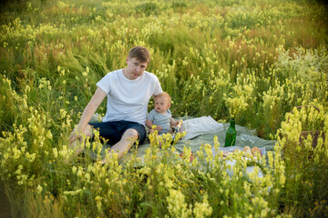 Dad and son in the summer field. Dad playing with his son.