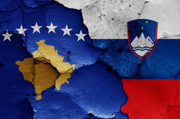 flags of Kosovo and Slovenia painted on cracked wall