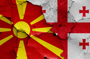flags of North Macedonia and Georgia painted on cracked wall