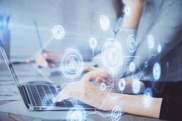 Double exposure of woman hands working on computer and data theme hologram drawing. Tech concept.