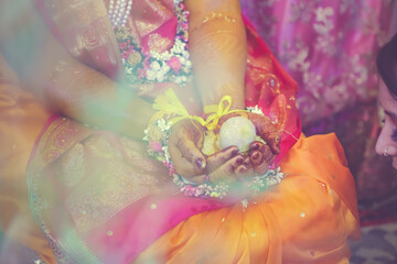 Indian Hindu pre wedding Haldi ceremony ritual items, decorations, hands close up