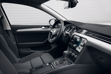 Modern car interior, with dashboard, fabric seats and navigation screen