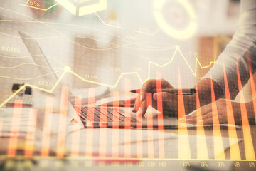 Double exposure of woman hands typing on computer and forex chart hologram drawing. Stock market...