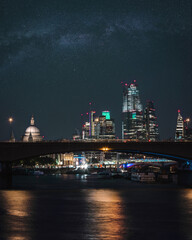 Bright nigh skyline of London city with the financial district skyscrapers, St Paul's Cathedral and the Thames river 