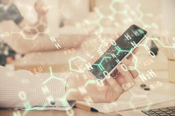 Double exposure of man's hands holding and using a phone and formulas drawing. Education concept.