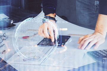 Multi exposure of man's hands holding and using a digital device and map drawing. International business concept.