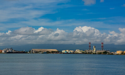 Point-a-Pitre, Guadeloupe - Sept 17, 2018: Cargo ship docked in the port of Pointe-a-Pitre in Guadeloupe. Blue sky with white clouds. Copy space