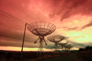 The silhouette of a radio telescope observatory