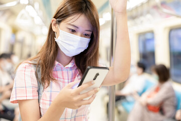 Girl use mobilephone on mrt