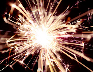 Close up of burning sparkler for 4th of July celebration.