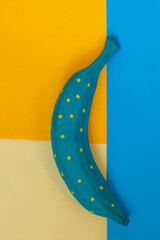 colored bananas on orange, blue cardboard