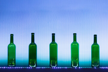 abstract empty wine bottles with blue led illumination