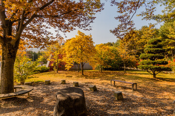 Park benches around large boulder
