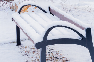 Park bench covered with snow