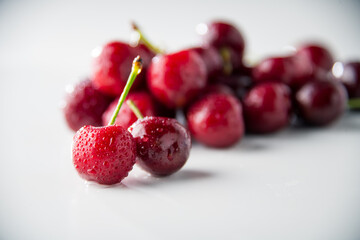Ripe red cherries on white background.