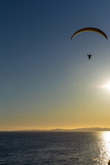 Parasailing during a golden sunset facing the horizon. Dallas   Road Victoria, British Columbia Canada 
