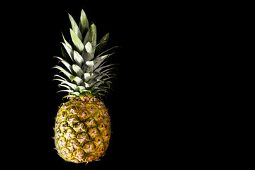 close-up of pineapple on a black background