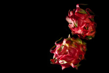 close-up of dragon fruits on a black background