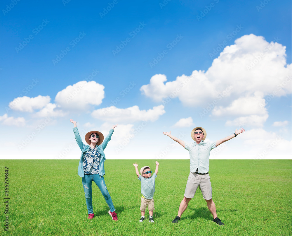 Wall mural happy  family standing on the grass and enjoy summer vacation