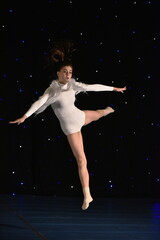 Fototapeta na wymiar Young teenage girl in white jersey perform modern dance