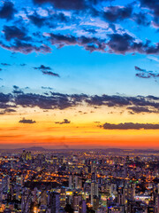 Vertical Cityscape View During Colorful Sunset and the Moon Seen From Water Tank Lookout in Belo Horizonte, Minas Gerais State, Brazil