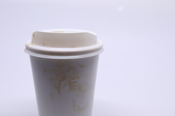 dirty brown stain on take away cup for hot coffee drink, paper mug on white background