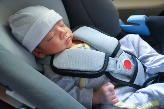 cute newborn baby sleeping in car seat safety belt lock protection drive road trip