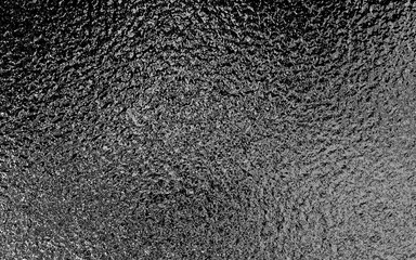 Black metallic foil paper texture background.