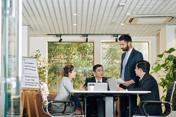 Business team working on new strategy of development and anti- crises measures