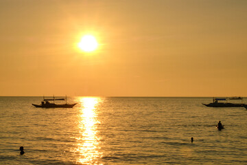 Boracay, Philippines - Jan 27, 2020: Sunset on Boracay island. Sailing and other traditional boats...