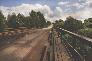 Fototapeta na wymiar Empty asphalt road in Russia Moscow region. Summer urbanistic landscape. Road bridge 